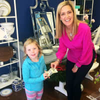 <p>Nantucket Monogram owner Brooke Boothe interacts with one of her younger customers.</p>