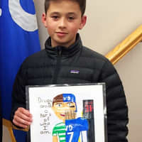 <p>Nicolas Lewis was honored by the mayor and council for his winning poster.</p>