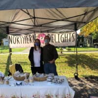 <p>Brandy North manning a booth at the Saugerties Farmers Market alongside her father.</p>