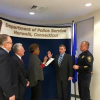<p>Norwalk Police Department officer Jim Mosher gets promoted to sergeant in a ceremony on Monday.</p>