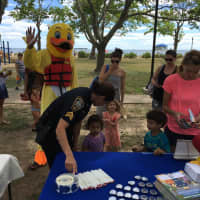 <p>Sgt. Sofia Gulino of the Norwalk Police Department talks to children during Saturday&#x27;s Water Safety Day at Calf Pasture Beach.</p>