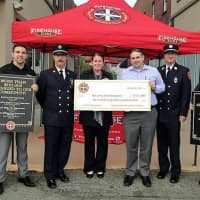 <p>Firehouse Subs presents the Oradell Fire Department with money for an inflatable search and rescue boat in a Totowa ceremony.</p>