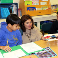 <p>Ossining teacher Micki Lockwood works with her Claremont Elementary School fourth-graders on their Tappan Zee Bridge project.</p>