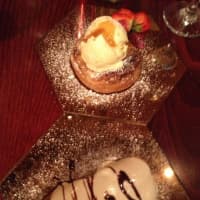 <p>Two of the yummy Italian desserts at Osteria Romana in Norwalk: a puff pastry stuffed with Nutella and topped with zabaglione and an apple tart with vanilla gelato, top.</p>