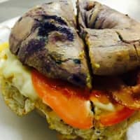 <p>The decadent blueberry bagel at Our Town Bagels &amp; Bakery in Mahopac holds stacks of egg, bacon, provolone, and tomato topped by pesto aioli.</p>