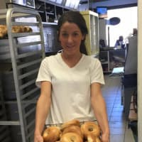 <p>Christina Evans gets a fresh batch ready at Our Town Bagels &amp; Bakery in Mahopac.</p>