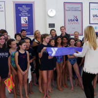 <p>Sydney Powers cuts the ribbon under her father’s memorial plaque at the YMCA of Greenwich.</p>