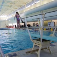 <p>Diver participates in a flip-a-thon to raise money for the YMCA of Greenwich using the new 1-meter diving board.</p>