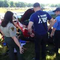 <p>Westport Fire personnel work to free a kitten trapped in a car at the Fairfield County Hunt Club Horse Show Wednesday.</p>