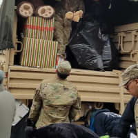 <p>U.S. Army reservists from the Teaneck Armory load a military vehicle with toys.</p>