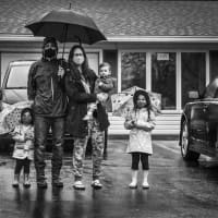<p>&quot;I started to encourage families to take whatever creative control they want. Needless to say this family did just that! It was raining outside so they posed with rain jackets and umbrellas. The result was beyond amazing one of my favorite photos.&quot;</p>