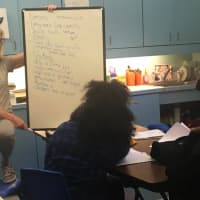 <p>Author and poet Page McBrier brainstorming with students from the Norwalk Housing Authority</p>