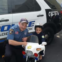 <p>Officer Chris Stanton helped Andrew, 4, celebrate his birthday</p>