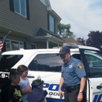 <p>Officer Stanton lets the partygoers check out his squad car</p>