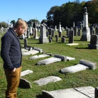 <p>Pastor Andy Kadzban of the Wyckoff Reformed Church surveys the damage done to century-old headstones in the church’s cemetery.</p>