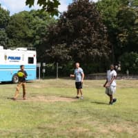 <p>Students throw a Frisbee with a Peekskill Police officer at the 2015 Real Talk Tailgate Party.</p>