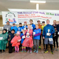 <p>Winners of each age category of the 5K Run pose for a photo.</p>