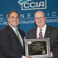 <p>Sen. Kevin Kelly accepts the 2016 Legislative Champion Award at the Annual Captive Insurance Symposium Oct. 13 at the Sheraton Stamford.</p>