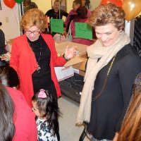 <p>Ann Spindel (red jacket) and Pat Brigham (white scarf), Director of Development for the Westchester Library System, made sure kids got the books they wanted.</p>