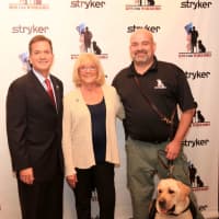 <p>Bill Huffnagle, president of Stryker’s Joint Replacement Division, welcomed K9s for Warriors founder Shari Duval and Army and Marine veteran James Brereton with his service dog, Bernie.</p>