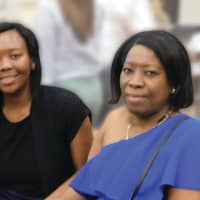 <p>Smelanda Jean Baptiste seated with her mother</p>