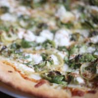 <p>Terra in Danbury serves pizza with brussels sprouts, goat cheese,  thin-sliced lemon, mozzarella and a balsamic glaze.</p>