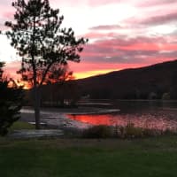 <p>Laura Brescia submitted this shot of a multicolored sky over Pinecliff Lake in West Milford.</p>