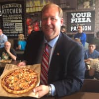 <p>Clarkstown Supervisor George Hoehmann with his pizza at PizzaRev.</p>