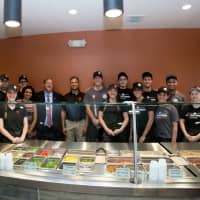 <p>PizzaRev owner Satyen Shah (middle) with Clarkstown Supervisor George Hoehmann and the PizzaRev staff.</p>