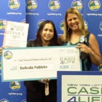 <p>Belind Poblete, left, won a jackpot of $7 mllion playing the CASH4LIFE game. With her is lottery personality Yolanda Vega.</p>