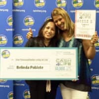 <p>Rockland resident Belinda Poblete, left, poses with lottery personality Yolanda Vega after winning the CASH4LIFE jackpot last spring. Poblete is planning to invest some of her millions in a yogurt and juice bar cafe in Nanuet.</p>