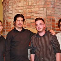 <p>Posto&#x27;s crew poses for a &quot;family&quot; shot. From left, they are: Sammy, Matt, Dino, and Patrick Amedeo, the owner.</p>