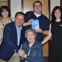 <p>Front row: Ron Suskind, Pulitzer Prize-winning journalist and author of &quot;Life, Animated&quot; shakes hands with Kit Peterson, Back Row: Karla Peterson, Zachary Peterson-Bernhard, Eliza Bozenski, Director of the Anderson Foundation for Autism</p>