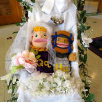 <p>The happy couple -- the letters &quot;Q&quot; and &quot;U&quot; -- are bedecked with flowers at their wedding at the Increase Miller Elementary School in Lewisboro.</p>