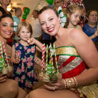 <p>Rockettes pose with a young fan at Main Street Sweets.</p>