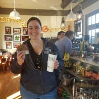 <p>Gabby Jordan of Stamford enjoys a Nutella doughnut on the opening day of Donut Crazy at the Westport Train Station on Friday.</p>