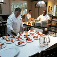 <p>Chef/owner Peter X. Kelly, left, puts the finishes touches on some goodies at Restaurant X and Bully Bar in Congers.</p>
