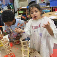 <p>Children make objects out of ice pop sticks at the Ramapo After School Program (RASP) at the Kakiat Elementary School in Spring Valley. The struggling program is on hold while it and East Ramapo school officials work out financial and space issues.</p>