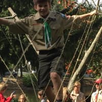 <p>A happy Scout traverses the rope bridge.</p>