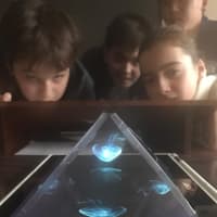 <p>For their projects, the ninth-graders used transparency paper, which they cut into four trapezoid pieces and taped together, to create a holographic projector before placing it directly on top of an iPad.</p>
