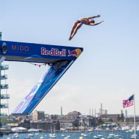 <p>Aidan Heslop of the UK dives from the 28 meter platform during final competition day at the Red Bull Cliff Diving World Series in Boston on June, 4 2022.</p>
