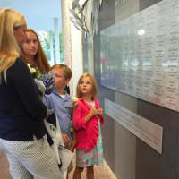 <p>Emma Hunt, 15, second from left, who lost her father William Hunt of Norwalk in the 9/11 attacks, looks at her aunt Debra Woodward on Thursday at the state&#x27;s 9/11 Memorial in Westport. Woodward&#x27;s children Colin, 10, and Molly, 7, are also pictured.</p>