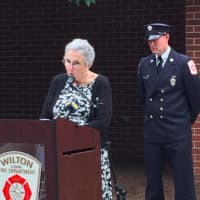 <p>Wilton resident Sandy Mumbach speaks during the town&#x27;s 9/11 ceremony. Behind her is Wilton Fire Department Lt. Jim Blanchfield.</p>