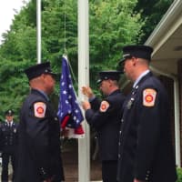 <p>Firefighter William Wilson, center, raises the flag during Wilton&#x27;s 9/11 ceremony on Friday. At right is Lt. Brian Elliott and at left is firefighter Dave Chaloux. Capt. Kevin Czarnecki is facing Wilson behind Chaloux.</p>