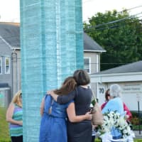 <p>Families hug at the Danbury 9/11 Memorial in Elmwood Park after Friday evening&#x27;s ceremony. </p>