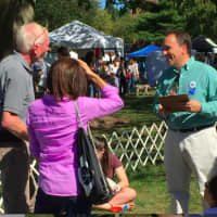 <p>Greenwich First Selectman Peter Tesei, who served as a judge at Adopt-A-Dog&#x27;s &quot;Puttin&#x27; On The Dog,&quot; jokes with a couple of dog owners Sunday.</p>