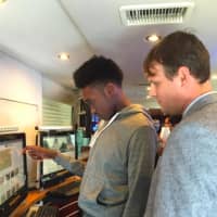 <p>Lenold Augustine, left, a Grade 12 student at Westhill High School looks at a screen inside the C-SPAN Campaign 2016 Bus that was at the school on Thursday. Looking on is Assistant Principal Chase Dunlap. </p>