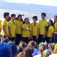 <p>Staples High School&#x27;s a cappella group The Orphenians sing the National Anthem at the Colorflash at Sherwood Island State Park in Westport. </p>