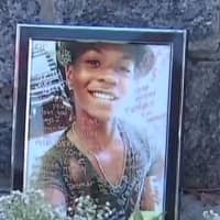 <p>A photograph of Tahj Robinson in an impromptu memorial set up near Barhardt Park by friends of the slain teen.</p>