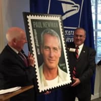 <p>Newman&#x27;s Own Foundation CEO and President Robert Forrester shows off the new Paul Newman stamp. </p>